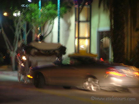 horse and carriage and car in Delray Beach at night