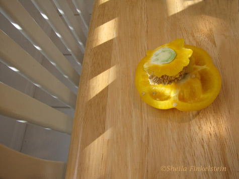 yellow pepper on table and chair back reflections