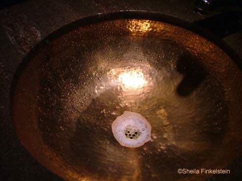 water in a bronze sink in Cheesecake Factory